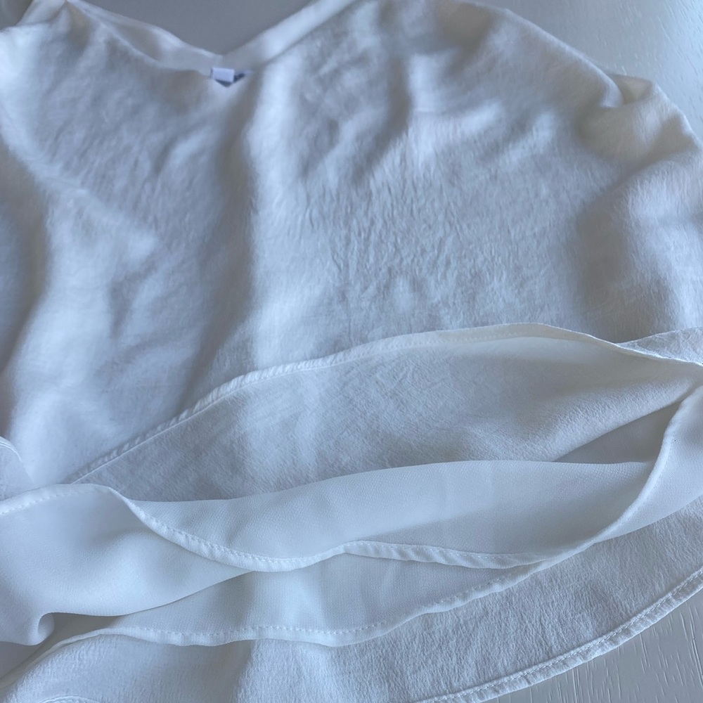 Very silky white tank top. Very elegant can be styled up or down.